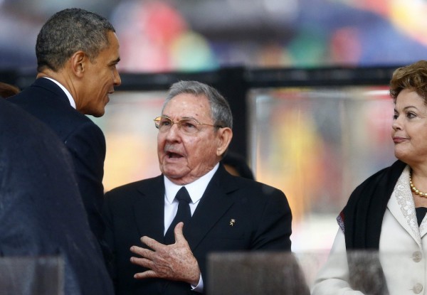 U.S. President Obama greets Cuban President Castro at the memorial service for Mandela in Johannesburg