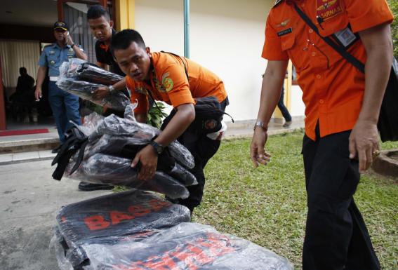 Search and rescue workers prepare to load body bags onto a flight to Kalimantan in Pangkal Pinang