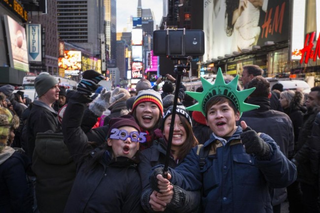 A family takes a selfie during New Year's Eve celebrations in Times Square, New York