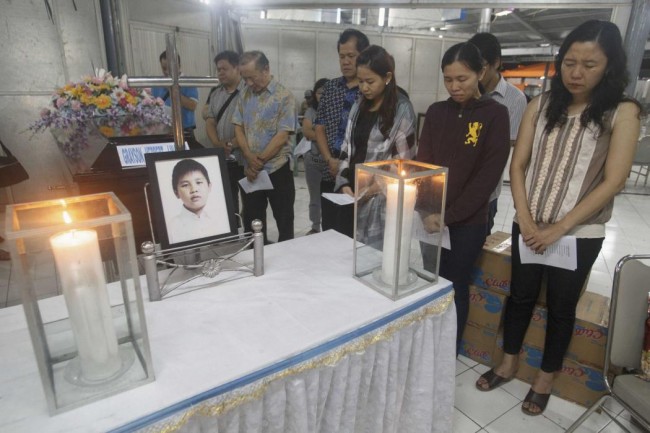 Family members of Grayson Herbert Linaksita, a passenger of AirAsia Flight QZ8501, attend his cremation at The Adijasa crematorium in Surabaya