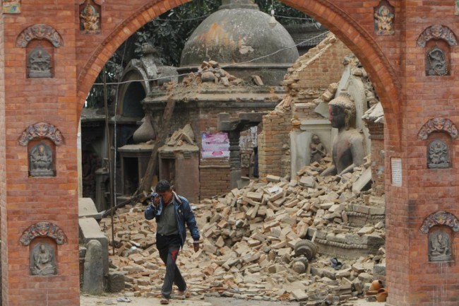 A Nepalese man cries as he walks through the earthquake debris in Bhaktapur, near Kathmandu, Nepal, Sunday, April 26, 2015. A strong magnitude 7.8 earthquake shook Nepal's capital and the densely populated Kathmandu Valley before noon Saturday, causing extensive damage with toppled walls and collapsed buildings, officials said. (AP Photo/Niranjan Shrestha)