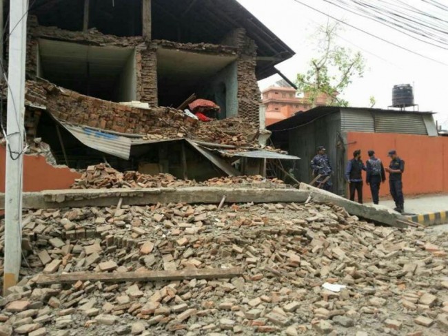 In this photo released by China's Xinhua News Agency, a collapsed building is seen in Nepal's capital Kathmandu Saturday, April 25, 2015. A strong earthquake shook Nepal's capital and the densely populated Kathmandu Valley before noon Saturday, causing extensive damage with toppled walls and collapsed buildings, officials said. (Zhou Shengping/Xinhua via AP) NO SALES
