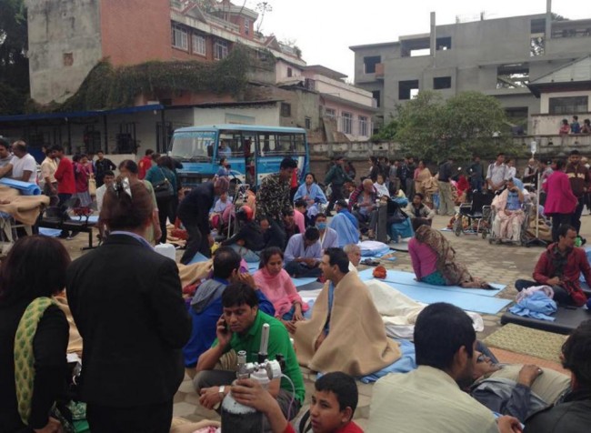 Patients wait at the parking lot of Norvic International Hospital after an earthquake hit Kathmandu, Nepal, Saturday, April 25, 2015. A powerful, magnitude-7.9 earthquake shook Nepal's capital and the densely populated Kathmandu Valley before noon Saturday, collapsing houses, leveling centuries-old temples and cutting open roads in the worst temblor in the Himalayan nation in over 80 years. (AP Photo/Binaj Gurubacharya)