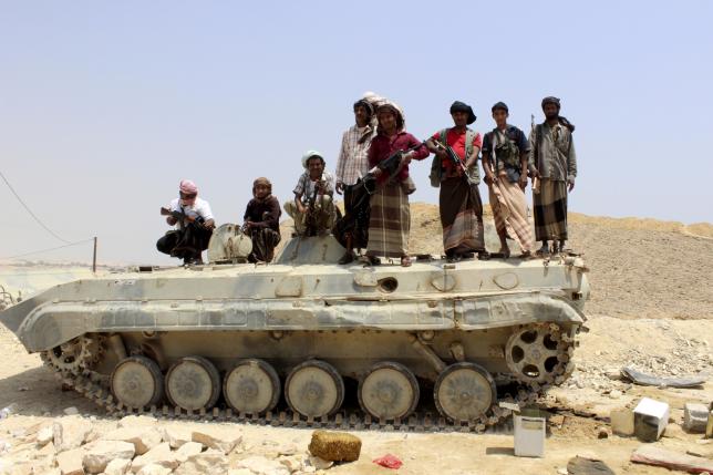 Tribesmen stand on a military vehicle they took from an army base in Shihr city of Yemen's eastern Hadramawt province April 4, 2015. REUTERS/Omer Arm