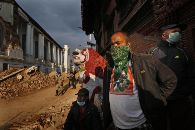 In this Wednesday, April 29, 2015 photo, Nepalese students and volunteers clear the rubble at Kathmandu Durbar Square, a UNESCO World Heritage Site, in Kathmandu, Nepal. (AP Photo/Manish Swarup)