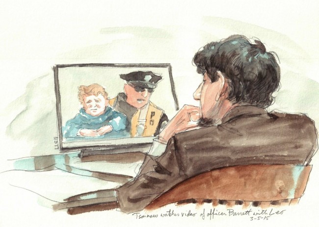Dzhokhar Tsarnaev watches a video of Boston Police officer Barret carrying 3-year-old Leo during the Boston Marathon bombing trial on March 5, 2015.