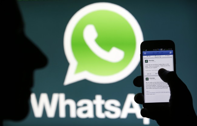 A Whatsapp App logo is seen behind a Samsung Galaxy S4 phone that is logged on to Facebook in the central Bosnian town of Zenica, February 20, 2014. Facebook Inc will buy fast-growing mobile-messaging startup WhatsApp for $19 billion in cash and stock in a landmark deal that places the world's largest social network closer to the heart of mobile communications and may bring younger users into the fold. REUTERS/Dado Ruvic (BOSNIA AND HERZEGOVINA - Tags: BUSINESS) - RTX196EP