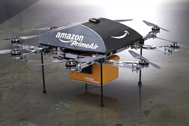 An Amazon PrimeAir drone is shown in this publicity photo released to Reuters on December 2, 2013. Amazon.com CEO Jeff Bezos told the CBS television program "60 Minutes" that the company is testing the use of delivery drones that could deliver packages that weigh up to five pounds (2.3 kg), which represents roughly 86 percent of packages that Amazon delivers, he said. REUTERS/Amazon.com/Handout via Reuters(UNITED STATES - Tags: BUSINESS SCIENCE TECHNOLOGY) ATTENTION EDITORS - THIS IMAGE WAS PROVIDED BY A THIRD PARTY. FOR EDITORIAL USE ONLY. NOT FOR SALE FOR MARKETING OR ADVERTISING CAMPAIGNS. NO SALES. NO ARCHIVES.THIS PICTURE IS DISTRIBUTED EXACTLY AS RECEIVED BY REUTERS, AS A SERVICE TO CLIENTS